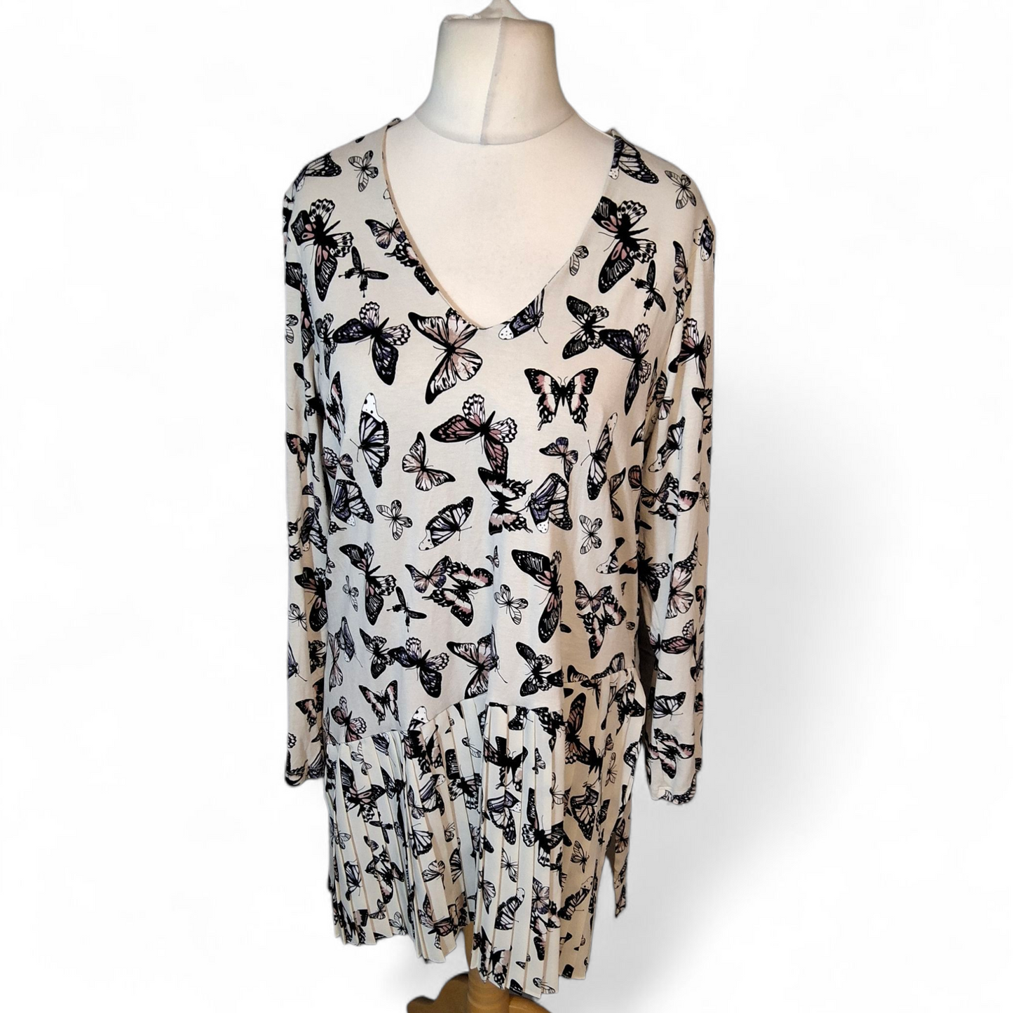 Long-sleeve top with butterfly pattern on a mannequin against a white background Per Una