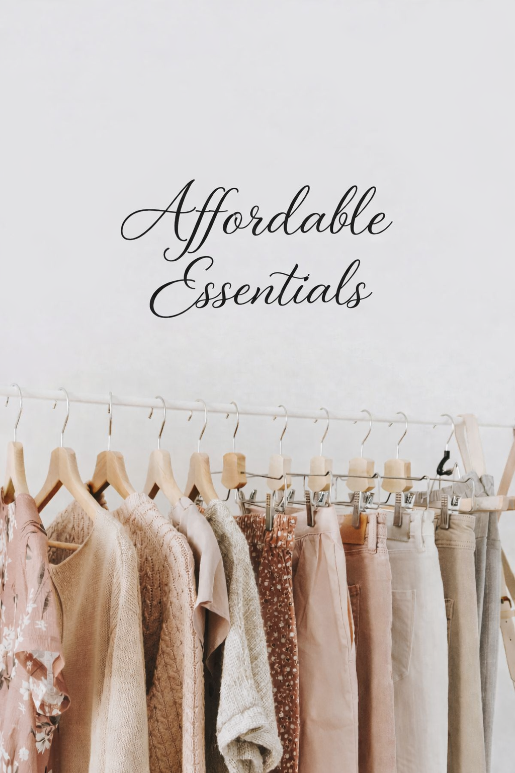 A clothing rail of affordable preloved tops and trousers in soft neutral colours, displayed as part of the Affordable Essentials collection.