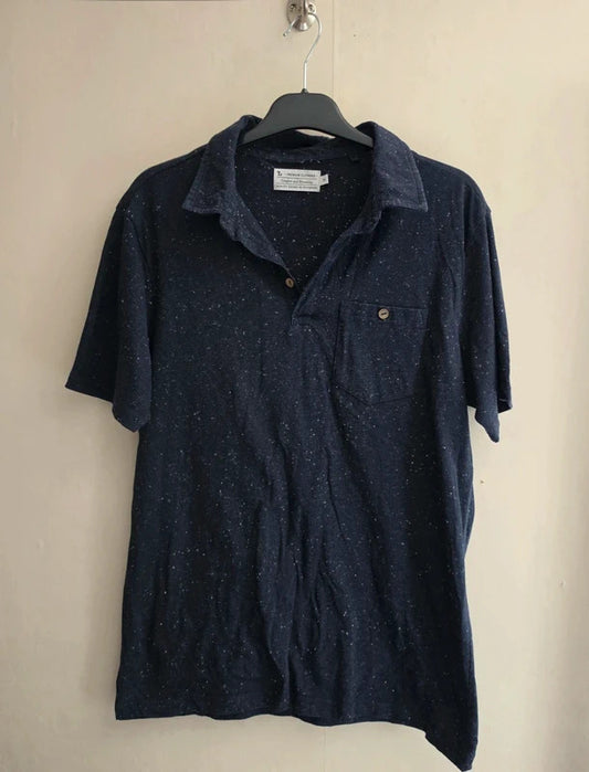 A dark navy blue short-sleeve polo shirt with a subtle speckled texture, hanging on a black hanger against a plain beige wall.