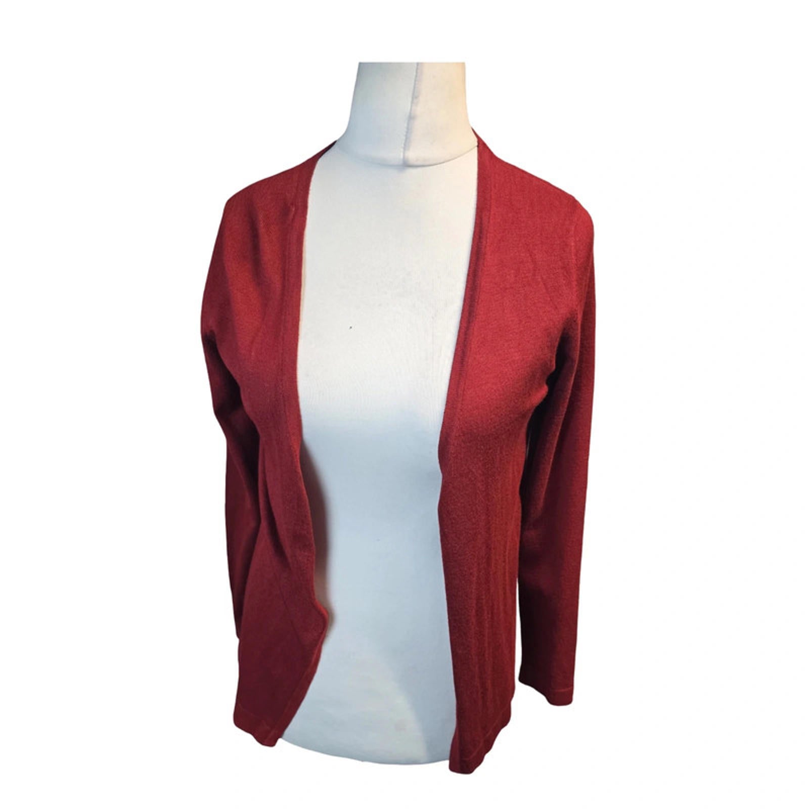 Red cardigan on a mannequin against a white background