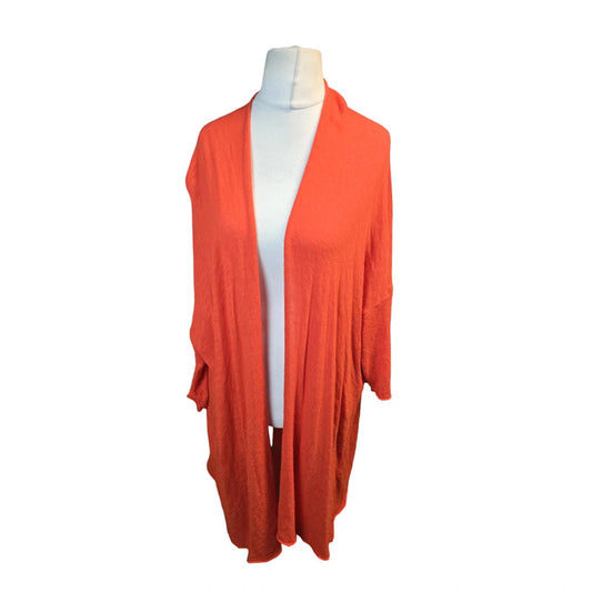 Orange cardigan on a mannequin against a white background