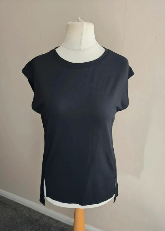 A dark black  short-sleeve top displayed on a white dress form mannequin against a plain beige wall.