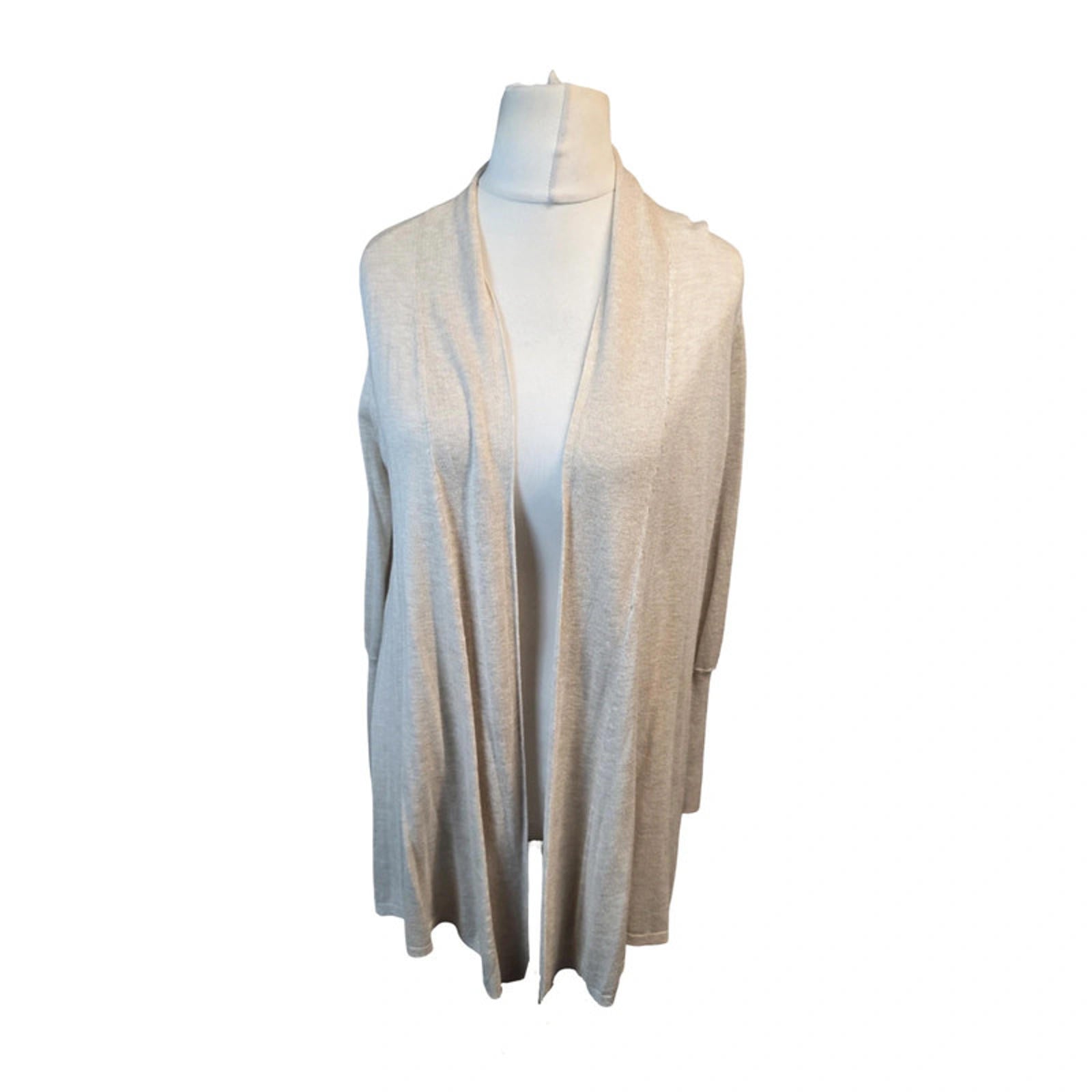 White cardigan on a mannequin against a white background