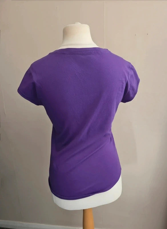 A purple short-sleeve crewneck t-shirt displayed on a white dress form mannequin, viewed from the back against a plain beige wall.